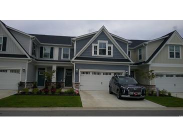 Two-story townhome with gray siding, two-car garage, and landscaping at 325 Golan Circle # 12B, Myrtle Beach, SC 29579