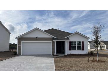 Charming single-story home featuring a two-car garage and beautifully landscaped front yard at 3450 Ashridge Way, Conway, SC 29526