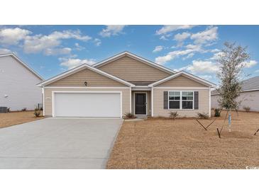 Tan house with white garage door and landscaping at 3457 Ashridge Way, Conway, SC 29526