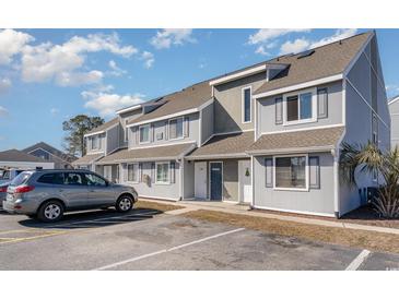 Gray building exterior with parking and landscaping at 1891 Colony Dr. # 13D, Surfside Beach, SC 29575