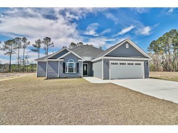 Newly constructed home with gray siding, two-car garage, and landscaped lawn at 340 William Nobles Rd., Aynor, SC 29511
