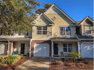 Two-story townhome with a garage and landscaping at 437 Red Rose Blvd. # 5, Pawleys Island, SC 29585