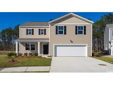 Two-story house with beige siding, white garage door, and landscaping at 511 Firouz Dr, Longs, SC 29568