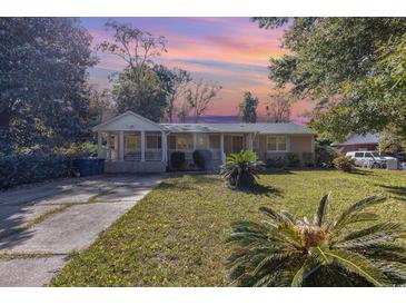 Tan house with front porch and large yard at 709 63Rd Ave. N, Myrtle Beach, SC 29572