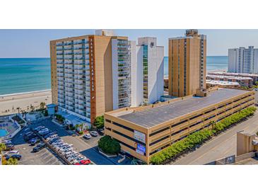 Aerial view of SandOcean Club, showing building, parking lot, and beach at 9550 Shore Dr. # 429, Myrtle Beach, SC 29572