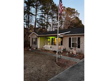 Charming one-story home with landscaped yard and American flag at 106 Fonza St., Conway, SC 29526