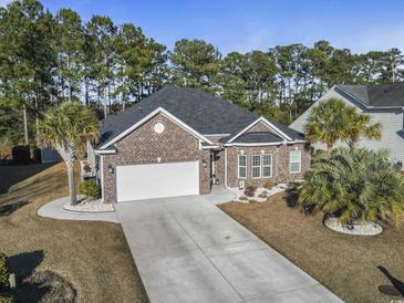 Brick house with 2-car garage, landscaping, and long driveway at 144 Shenandoah Dr., Murrells Inlet, SC 29576