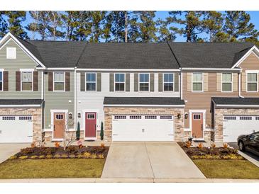 Three-unit townhome development showcasing attractive exteriors and landscaping at 324 Golan Circle # B, Myrtle Beach, SC 29579