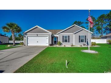 One-story home with gray siding, two-car garage, and manicured lawn at 575 Mossbank Loop, Longs, SC 29568