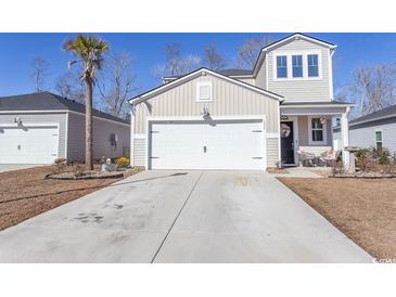 Two-story house with a white garage door and landscaping at 136 Timber Oaks Dr., Myrtle Beach, SC 29588