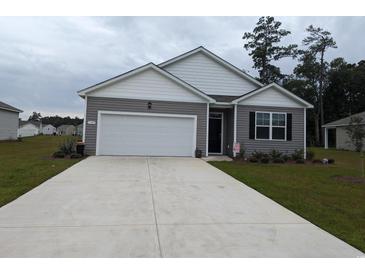 Curb appeal abounds in this charming one-story home featuring a two-car garage at 1455 Porchfield Dr., Conway, SC 29526