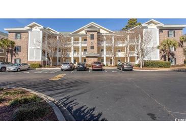 Brick building exterior with parking lot and landscaping at 4809 Luster Leaf Circle # 102, Myrtle Beach, SC 29577