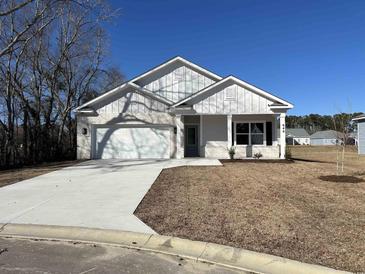White brick home with gray door and two-car garage at 640 Carter Reid Ct., Conway, SC 29526