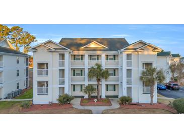 Charming condo complex featuring multiple balconies, lush landscaping, and well-maintained exterior at 661 Tupelo Ln. # 16B, Longs, SC 29568