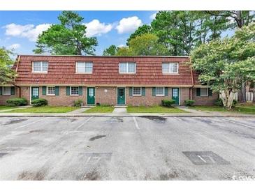 Two-story brick townhomes with parking and grassy front yards at 1025 Carolina Rd. # I-7, Conway, SC 29526