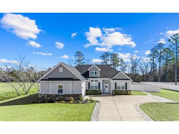 Gray house with stone accents, driveway, and landscaped lawn at 121 Stonehinge Ct., Conway, SC 29526