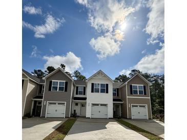 New townhomes feature various neutral-colored exteriors and convenient attached one car garages in a friendly community at 265 Christiana Ln. # B, Myrtle Beach, SC 29579