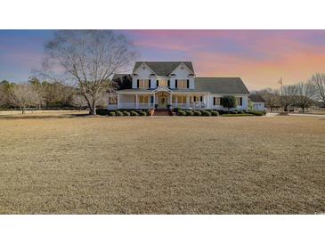 Two-story home with wrap-around porch and landscaped yard at 3658 Edwards Rd., Aynor, SC 29511