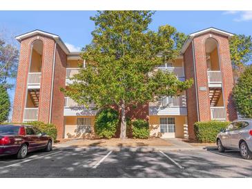 Brick building exterior with parking and landscaping at 4251 Villas Dr. # 303, Little River, SC 29566