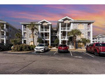 Brick building exterior with parking and landscaping at 4773 Wild Iris Dr. # 5-202, Myrtle Beach, SC 29577
