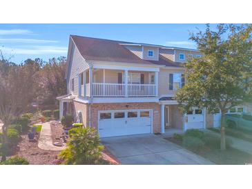 Two-story townhome with brick facade, balcony, and attached garage at 502 Hay Hill Ln. # B, Myrtle Beach, SC 29579