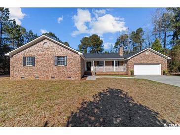 Brick ranch house with attached garage and front porch at 63 Floranada Ln, Georgetown, SC 29440