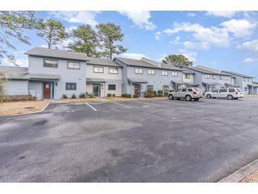 Exterior view of townhouses with parking and landscaping at 775 Plantation Dr. # 48, Little River, SC 29566