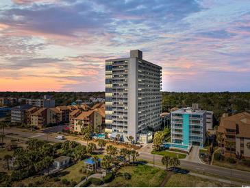 Stunning aerial view of a high-rise condominium building near the beach, with pools and beautiful landscaping at 5511 N Ocean Blvd. # 302, Myrtle Beach, SC 29577