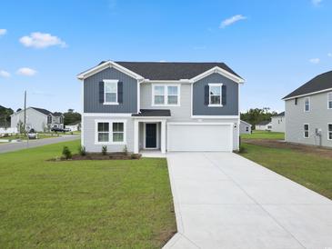 Two-story house with gray siding, white trim, and a two-car garage at 1032 Kinness Dr., Conway, SC 29527