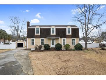 Two-story house with a gable roof, landscaping, and driveway at 112 Staton Ln., Longs, SC 29568