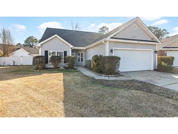Charming single-story home with a well-manicured lawn and attached two-car garage at 1209 Peyton Ct., Myrtle Beach, SC 29588