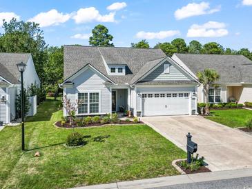 Charming one-story home with attached garage, manicured lawn, and colorful landscaping at 2450 Craven Dr., Myrtle Beach, SC 29579