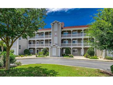 Attractive three-story building with balconies and landscaping at 4200 Coquina Harbour Dr. # H3, Little River, SC 29566