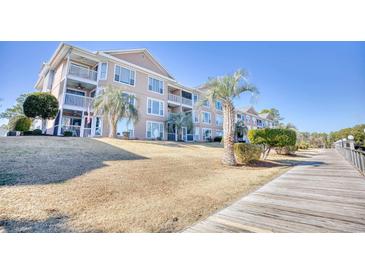 Exterior of a condo building with a walkway and landscaping at 4629 Lightkeepers Way # 6-I, Little River, SC 29566
