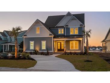 Charming craftsman style home with a well-manicured lawn, inviting front porch, and a concrete driveway at twilight at 477 Starlit Way, Myrtle Beach, SC 29579