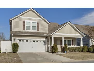 Charming two-story home with neutral siding, a two-car garage, and a welcoming front porch at 5314 Abbey Park Loop, Myrtle Beach, SC 29579