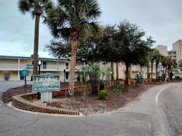 Oceanfront Inn with palm trees and convenient registration at 1 Norris Dr. # 219, Pawleys Island, SC 29585