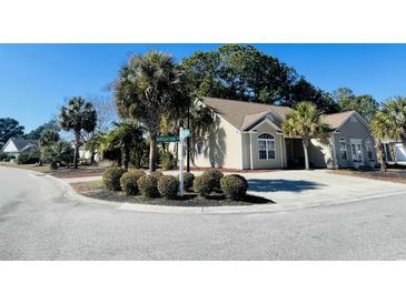 Charming single-story home featuring mature landscaping, a circular driveway, and a well-maintained exterior at 1501 Brighton Ln., Longs, SC 29568