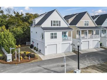 White two-story home with attached garage and landscaped yard at 244 Gloucester Way, Little River, SC 29566