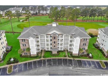 Exterior view of a multi-story condo building with golf course views at 4894 Luster Leaf Circle # 304, Myrtle Beach, SC 29577