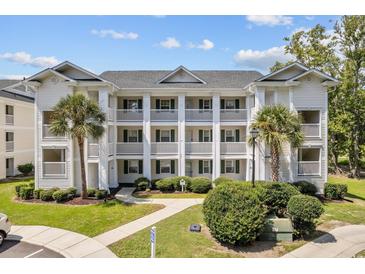 Two-story building with multiple units, balconies, and landscaping at 565 White River Dr. # 10-E, Myrtle Beach, SC 29579