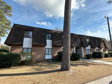 Brick building exterior with a brown roof and landscaping at 615 Carter Ln. # B4, Conway, SC 29526