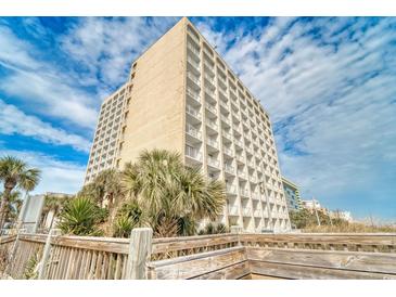 Low angle exterior shot of a multi-story condo building with white balconies and palm trees on a sunny day at 1207 S Ocean Blvd. # 20701, Myrtle Beach, SC 29577