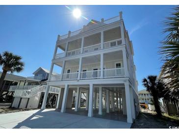 Coastal home with a multi-tiered covered porch offering ocean views and ample outdoor space at 229 South Waccamaw Dr., Garden City Beach, SC 29576