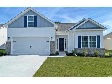 Charming single-Gathering home with a two-car garage, manicured lawn, and inviting front porch at 407 Lifestyle Court, Surfside Beach, SC 29575