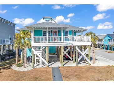 Charming elevated beach house with a spacious deck and ocean views at 923 N Waccamaw Dr., Garden City Beach, SC 29576