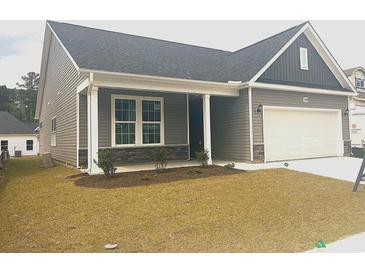 Charming exterior of a one-story home featuring a covered porch and attached garage at 1099 Nw Forest Bend Dr., Calabash, NC 28467