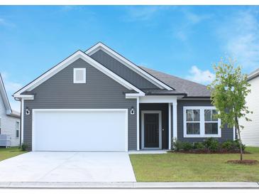 Charming single-Gathering home with gray siding, a two-car garage, and a well-manicured lawn at 1336 Winding Creek Way, Myrtle Beach, SC 29588