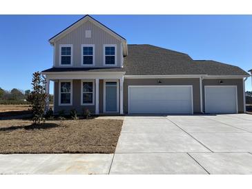 Two-story house with neutral siding, three-car garage, and a small front yard at 135 Joyce Dr, Longs, SC 29568