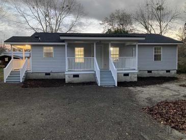 Charming single-story home featuring a covered front porch and a freshly landscaped yard at 206 W Pine St., Johnsonville, SC 29555